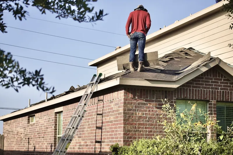 Professional roofer working on a residential roof in Town Hall
